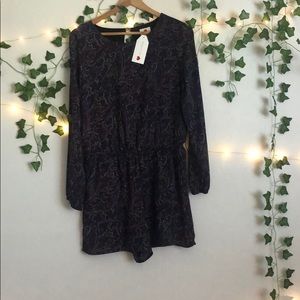 purple romper with designs on it